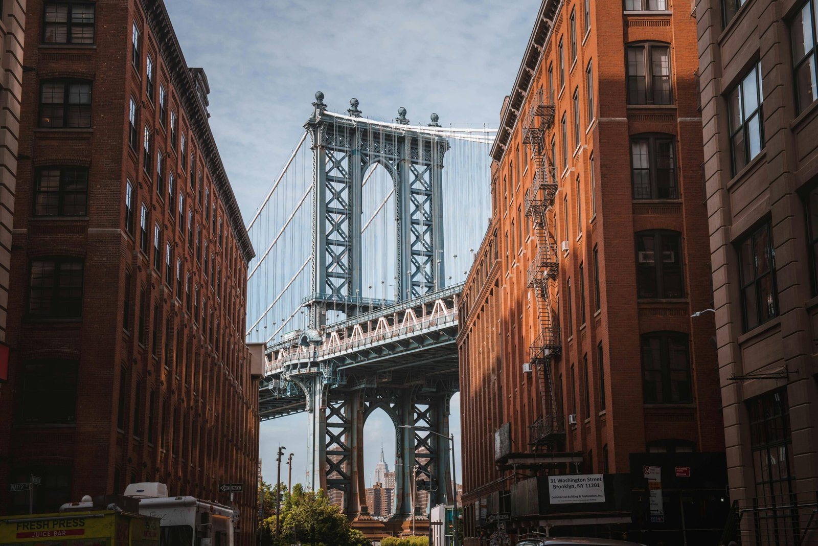 pexels-photo-2706653-2706653 Stunning view of the Manhattan Bridge framed by red-brick buildings in New York City's DUMBO neighborhood.